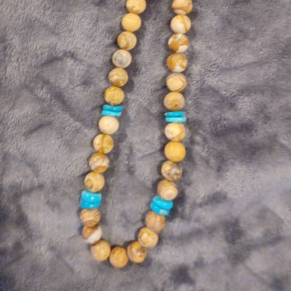 Turquoise coin bead and tan and brown round bead necklace. 20 inches long.